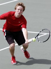 Lawrence High's Thomas Irick plays a ball near the net during an LHSl tennis Invitational Friday at LHS.