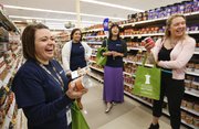 During a grocery store tour Thursday at Dillons, 1015 W. 23rd St., Jolene Croxell of the Lawrence-Douglas County Health Department and other participants react with surprise when discovering the sodium content of some canned vegetables. Pictured clockwise to the right of Croxell are health department AmeriCorps members Beeta Kashani and Amanda Kong, and Kelsey Fortins, a health educator at Kansas University's Watkins Memorial Health Center.