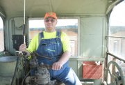 Mike Beem sits at the controls of one of two Midland Railway locomotives in use Saturday. A lifelong train fanatic, Beem took a course at Johnson County Community College to add engineer to the list of volunteer jobs he performs at the Baldwin City excursion line.