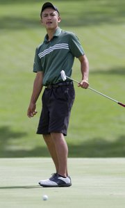 Free State golfer Jack Flynn putts during the Class 6A boys golf state tournament Tuesday, May 27, 2014, at Topeka Country Club.