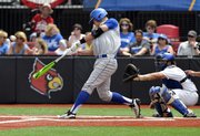 Kansas' Connor McKay, center, hits a foul against Kentucky during an NCAA college baseball regional tournament game in Louisville, Ky., Friday, May 30, 2014. Catching is Kentucky's Michael's Thomas. (AP Photo/Timothy D. Easley)