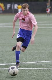 Free State’s Carson Gilliland runs attack drills during the Firebirds’ summer soccer clinic, Friday, June 6, 2014, at FSHS.