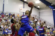 Blue Team guard Frank Mason takes the ball to the hoop over Red Team guard Devonte Graham during a scrimmage on Wednesday, June 11, 2014 at the Horejsi Center.
