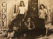 Ron Light, top right, as the guitarist and lead singer in a band as a young man. This photo is taped to the side of shelf in his room at Pioneer Ridge.