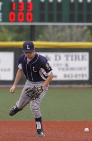 A ground ball slips by Lawrence Raider shortstop Nate Hulse in the Raiders’ 12-0 loss to the BC Cubs, Saturday, June 14, 2014, at Free State High.