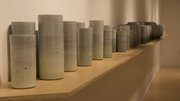 Kyla Strid&squot;s exhibition "Waggle Dance", which opened Friday at the Lawrence Arts Center, includes ceramic cylinders that resemble grain elevators with color that goes from light to dark.