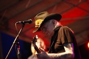 Legendary blues player Johnny Winter performs during a free concert Wednesday night outside of the Lawrence Arts Center.