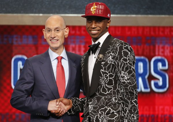 NBA Commissioner Adam Silver, left, congratulates Andrew Wiggins of Kansas who was selected by the Cleveland Cavaliers as the number one pick in the 2014 NBA draft, Thursday, June 26, 2014, in New York. (AP Photo/Jason DeCrow)