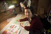 Toy Store assistant manager and artist Grace Chin works on a window display for the store last year.