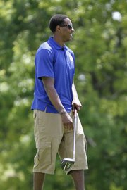 Miami Heat point guard and former Kansas University standout Mario Chalmers watches a practice tee shot during the Sixth Annual Mario V. Chalmers Foundation Golf Tournament & VIP Mixer at Alvamar Golf Club Monday.