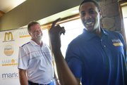 Miami Heat point guard and former Kansas University standout Mario Chalmers, right, and KU basketball coach Bill Self joke during the Sixth Annual Mario V. Chalmers Foundation Golf Tournament & VIP Mixer Monday at Alvamar Golf Club.