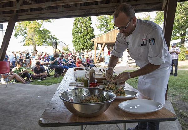 Rick Martin, head chef and owner of Limestone Pizza, plates his pork carnitas chopped salad served with the flat bread as he participates in the fourth annual Chef's Challenge on Wednesday, July 30, 2014, at the Douglas County fair. Martin won first place with his dish.