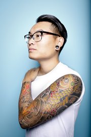 Travis Young has a full sleeve on his left arm which is composed of traditional Japanese art, including koi fish, cherry blossoms and waves.