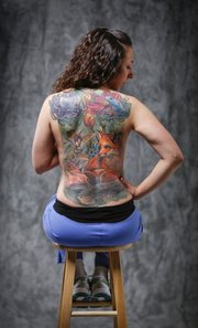 Katie Bledsoe's back features a natural scene to cover up three older tattoos that she no longer wanted. The full tattoo took 36 hours over several sessions to complete.
