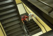 Rick McNabb, of Lawrence, left, climbs stairs at Lawrence Memorial Hospital on Friday while "coach" Jerry Waugh provides support and friendship. Four years ago, McNabb suffered an aneurysm that led to a stroke that left him paralyzed and without sensation on the left side of his body. McNabb is attempting to climb the equivalent of Mount Everest while raising money for charity. 