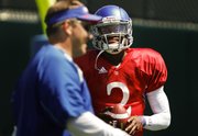 Kansas quarterback Montell Cozart has a laugh with quarterbacks coach Ron Powlus during practice on Monday, August 11, 2014 at the practice fields.