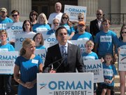 Greg Orman, right, an independent candidate for the U.S. Senate in Kansas, discusses his campaign during a news conference inJuly 2014, as his wife, Sybil, watches to his left on the south steps of the Statehouse in Topeka. Orman is portraying himself as the leading challenger for Republican Sen. Pat Roberts' seat.