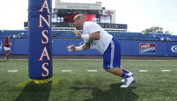 TJ Semke, a juior defensive lineman, stretches out before kickoff. KU hosted Central Michigan on Saturday September 20, 2014, at Memorial Stadium.