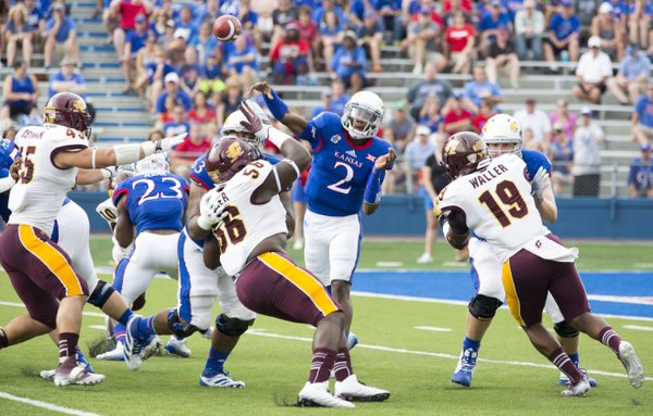 Kansas quarterback Montell Cozart (2) passes over the top of the Central Michigan defense during their game on Saturday afternoon at Memorial Stadium. 