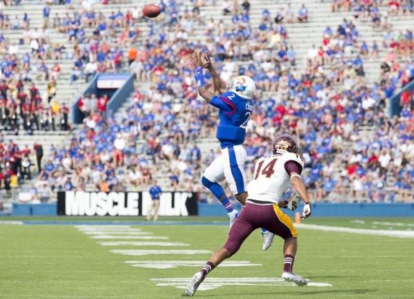 Quarterback turned receiver for a play, Kansas' Montell Cozart (2) leaps in front of Central Michigan defensive back Jason Wilson (14) for a reception on a half back pass during their game on Saturday afternoon at Memorial Stadium.