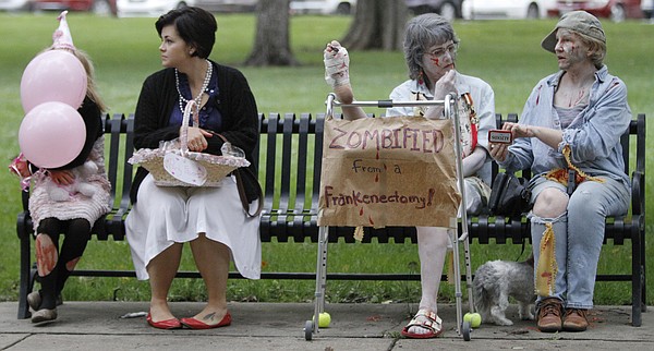 A park bench full of zombies wait for the start of the 8th annual Lawrence Zombie Walk Oct. 2, 2014.