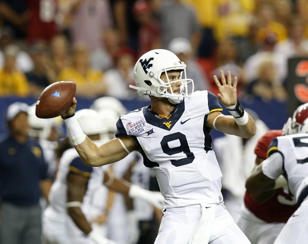 West Virginia quarterback Clint Trickett (9) throws a pass in the second half of an NCAA college football game against the Alabama Saturday, Aug. 30, 2014, in Atlanta. (AP Photo/Brynn Anderson)
