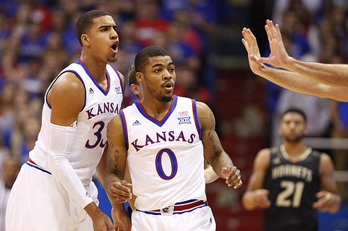 Kansas players Landen Lucas, left, and Frank Mason react to a push called against Mason during the first half on Tuesday, Nov. 11, 2014.