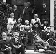 Seated at center, with white hair and black skirt, is Louise Gates Roberts Rouselaux, photographed with a group of early Lawrence settlers who had survived an 1856 raid on Lawrence as well as Quantrill's Raid in 1863. Reclining at lower right is Hugh 'Kansas Hermit' Cameron.