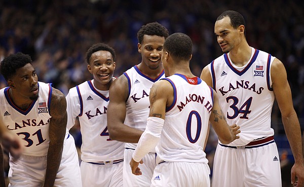 Kansas players Jamari Traylor, left, Devonte Graham, Wayne Selden and Perry Ellis surround Frank Mason before a pair of free throws by Mason during the second half on Friday, Dec. 5, 2014 at Allen Fieldhouse.