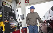 Mitch Reiber, Olathe, fills his car up with gas at the Zarco station at 1500 E. 23rd St. on Friday, Dec. 12. Reiber was filling up for a price of $2.34 for regular unleaded.