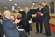 Romana Boniecka, left, accepts the Commander's Cross of the Order of Merit of the Republic of Poland with Star award Thursday at the Jayhawk Room in Kansas Union on behalf of her lifelong companion, Anna Cienciala, a retired history professor at Kansas University who died Dec. 24. The award recognizes individuals who have been of great service of Poland. Deputy Chief of Mission at the Embassy of the Republic of Poland Maciej Pisarski, center, and Consulate General of the Republic of Poland in Chicago Robert Rusiecki, right, presented the award. Seated, at left, is Victor Contoski, KU professor emeritus of English, who read a remembrance at the ceremony, which was also a memorial for Cienciala.