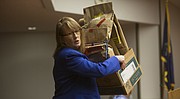 Assistant Douglas County District Attorney Amy McGowan moves some of the evidence into court as day two of Dustin D. Walker's first trial began on Feb. 10, 2015.