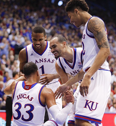 Kansas guard Wayne Selden Jr. (1), forward Perry Ellis, center, and guard Kelly Oubre Jr. celebrate with Kansas forward Landen Lucas (33) after Lucas took a charge from Baylor forward Rico Gathers (2) during the second half, Saturday, Feb. 14, 2015 at Allen Fieldhouse.