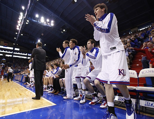 Team manager Chris Huey gets up to celebrate a Jayhawk bucket during the second half, Saturday, Feb. 21, 2015 at Allen Fieldhouse. Huey suited up as a walk on for the game.