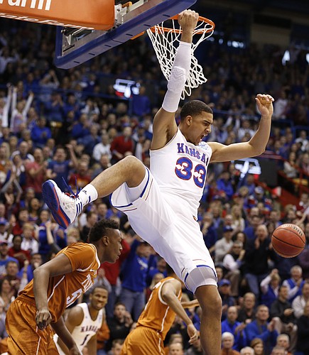 Kansas forward Landen Lucas (33) comes down from a dunk over Texas forward Myles Turner (52) during the first half on Saturday, Feb. 28, 2015 at Allen Fieldhouse.