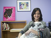 Kate Meghji, executive director at the Lawrence Humane Society, holds one of the shelter's dogs up for adoption in this March 2015 file photo.