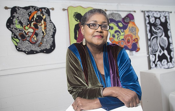 Quilter and historian Marla Jackson is pictured in front of her quilts on display at the Percolator, 913 Rhode Island St., as part of Jackson’s upcoming exhibition, “Tell Mama.” The exhibit, which opens during this month’s Final Friday, features 10 quilts that honor her mother, Fern Hill. 