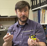 KU associate professor of aerospace engineering Ron Barrett-Gonzalez displays two small drones, or unmanned aerial vehicles (UAVs). He helped develop an instrument that enables sound-sensing anti-collision devices to be used outdoors, even on drones as small as these.