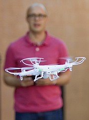 Journal-World Staff Photographer Nick Krug operates a Syma X5C quadcopter in the alley behind the Journal-World on Friday, May 1, 2015.