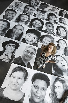 Lawrence photographer and artist Rachael Perry stands among a handful of the 650 portraits of local residents she photographed for the Lawrence Inside Out community photo project. Perry set out take black-and-white portraits of anyone who considered themselves part of the arts community. 