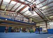Fourteen-year-old William Gallagher leaps high in the air off a balance beam during a parkour class held at Lawrence Gymnastics Academy, 4930 Legends Dr. on Sunday, May 17, 2015.
