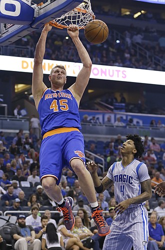 New York Knicks center Cole Aldrich (45) dunks the ball in front of Orlando Magic's Elfrid Payton (4) during the first half of an NBA basketball game, Saturday, April 11, 2015, in Orlando, Fla. New York won 80-79. (AP Photo/John Raoux)
