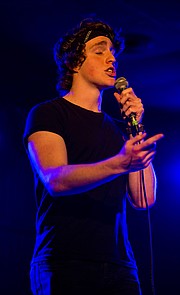 Hip-hop musician Huey the Phantom performs on stage at The Bottleneck during open mic night on Monday. The weekly events have begun drawing artists beyond the folk music genre normally associated with open mic nights.