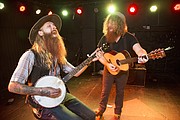 From left, Lawrence musicians Tyler Gregory and Nicholas St. James perform on the stage at The Bottleneck, 737 New Hampshire St. The two help organize and sometimes perform at weekly open mic nights at The Bottleneck and Jazzhaus.