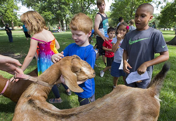 Lawrence Parks and Recreation outdoor day camper Cael Hetrick, 7, reaches out to give a hug to a dairy goat named Nutmeg as he and other campers get a glimpse of various farm animals on display, Monday, July 6, 2015 at South Park. Local 4-Hers spent part of the morning teaching the campers about the animals and also invited them to the Douglas County Fair. 