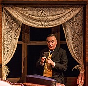 Sherlock Holmes, portrayed by Robert Brand, uses his trusty magnifying glass to inspect a clue during a dress rehearsal for Kansas Repertory Theatre&squot;s production of "Sherlock&squot;s Last Case" on Tuesday evening at Crafton-Preyer Theatre in Murphy Hall.