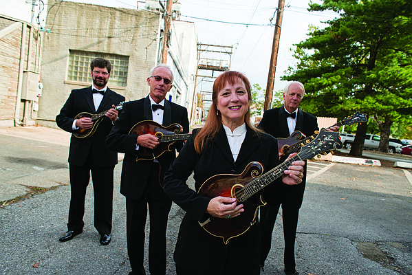 The Lawrence Uptown Mandolin Quartet is pictured in 2013 before the group's 40th anniversary. Members, pictured from left, are Mike Stewart, Charles Higginson, Beth Dearinger and Jeff Dearinger. During its existence, group has included as many as 30 musicians at one time. 