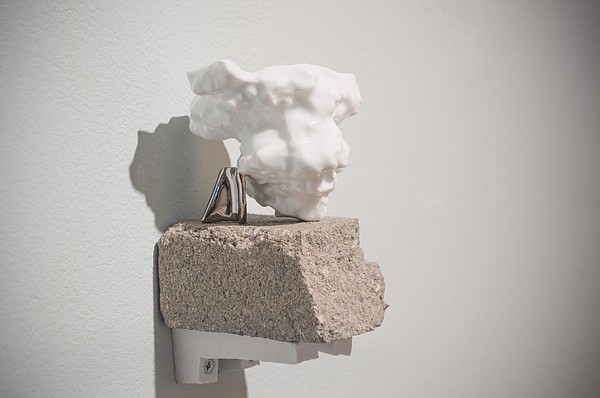 "Fragment" by Christy Wittmer. 2014. Porcelain with PVD, concrete, porcelain brackets. 5”x3”x4”