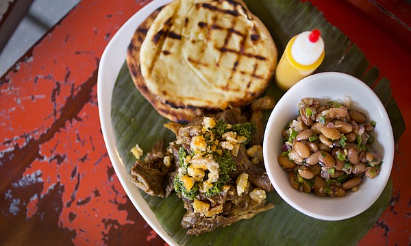 Yucatan-style pork with garlic masa flatbread, local pinto bean salad, chimichurri and chiccarones at Merchants Pub and Plate, 746 Massachusetts.