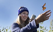 Mia Talley, 15, of Baldwin, releases a monarch butterfly after tagging it Saturday, Sept. 19, 2015, during Monarch Watch's monarch tagging event on the site of a wetland restoration project on the east side of Clinton Lake.